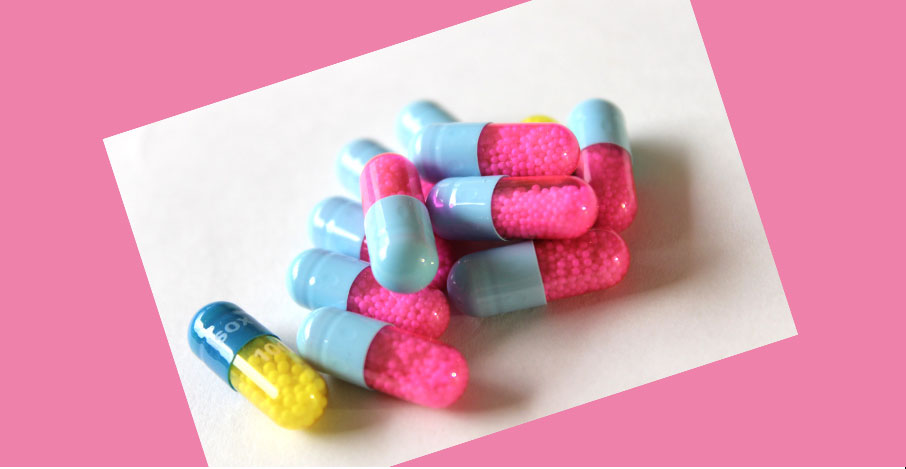 Capsules-pink-and-blue-yellow-and-blue-on-bright-pink-background