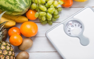 Good-health-with-eating-fresh-food-fruits-and-watching-weight-bathroom-scale