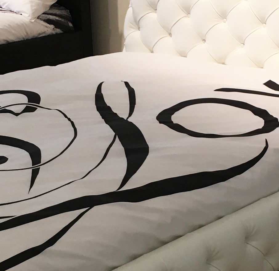 IQ-white-bed-displaying-ZayZay-duvet-cover-design-Love-Song-at-Mercatus-showroom-High-Point-Market