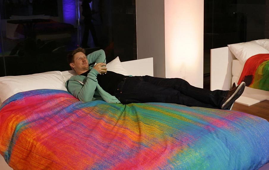 ZZ-B-Launch-party-guest-Brian-Malone-relaxing-on-bed-with-Tropical-Frost-duvet-cover