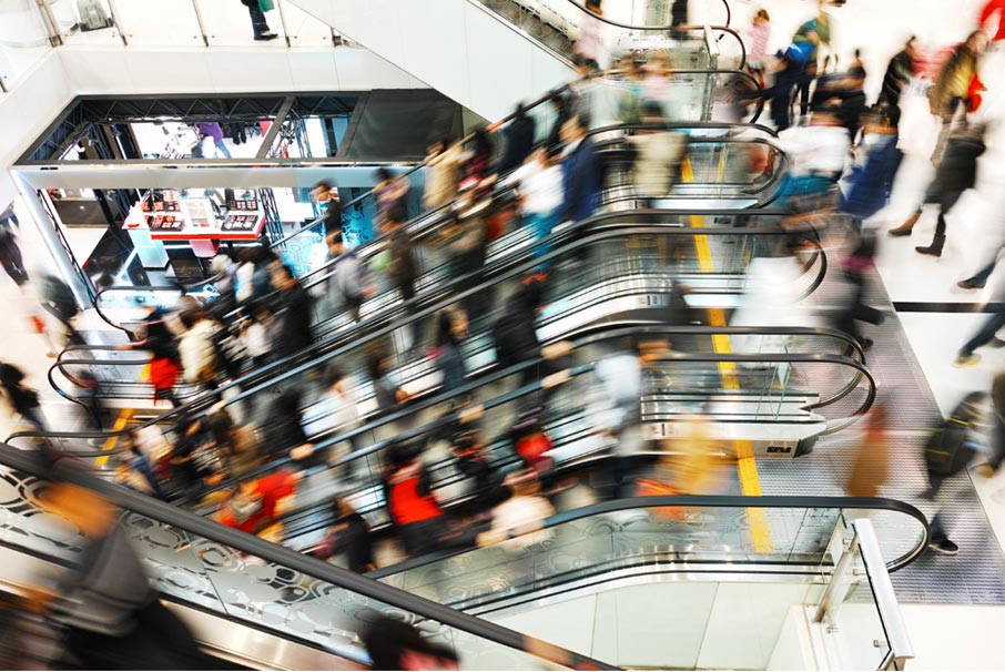 Blurred-escalators-packed-with-rushing-shoppers