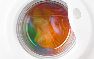 White-front-load-washer-with-colourful-laundry-inside