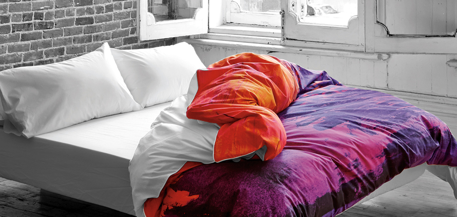 Saffron-Shangrilahh-duvet-cover-design-orange-and-purple-pulled-back-white-sheets-in-gray-bedroom